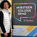 UC San Diego faculty member / lecturer posing near #firstgen sign