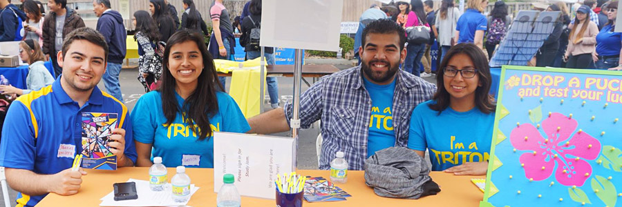 UC San Diego students serve as hosts at an information table